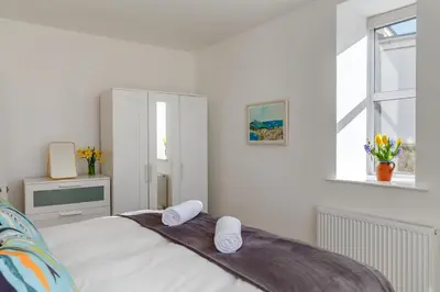 a white bedroom with a bed with towels on it at 2 Bed in St. Ives oc-1seab in St Ives