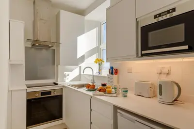 a white kitchen with a sink and a microwave at 2 Bed in St. Ives oc-1seab in St Ives