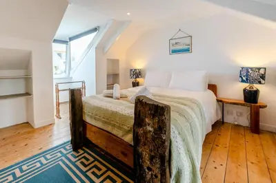 a bedroom with a large bed with a wooden floor at 2 Bed in St. Ives oc-6acarr in St Ives