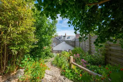 a garden with flowers and a house in the background at 2 Bed in St. Ives oc-6carr in St Ives