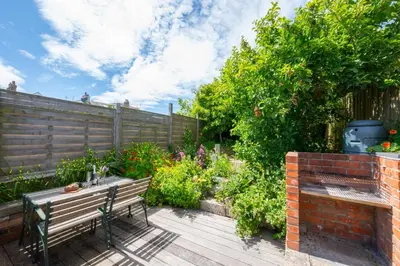 a wooden deck with a bench in a garden at 2 Bed in St. Ives oc-6carr in St Ives