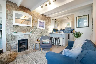 a living room with a blue couch and a fireplace at 2 Bed in St Ives oc-albt02 in St Ives