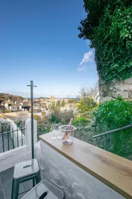 a balcony with a table and two glasses on it at 2 Bed in St Ives oc-albt02 in St Ives