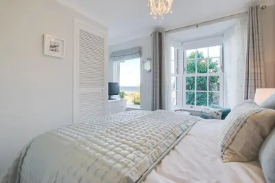 a white bedroom with a bed and a window at 2 Bed in St Ives oc-albt02 in St Ives
