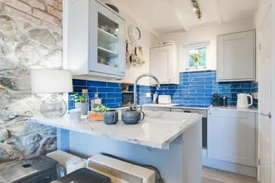 a kitchen with a sink and a blue tile wall at 2 Bed in St Ives oc-albt02 in St Ives