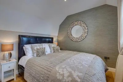 a bedroom with a bed and a mirror on the wall at 1 Bed in St. Ives oc-aqua19 in St Ives