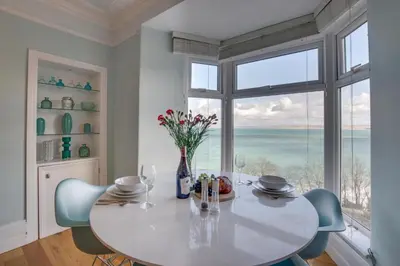 a dining room with a table and chairs and a large window at 1 Bed in St. Ives oc-aqua19 in St Ives