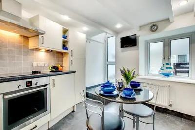 a kitchen with a small table and chairs in a kitchen at 3 Bed in St Ives oc-bail05 in St Ives