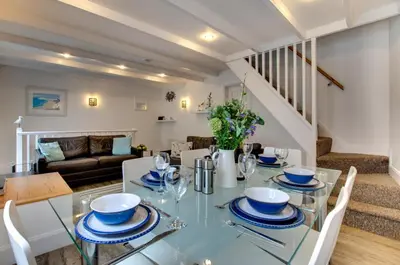 a dining room and living room with a glass table at 3 Bed in St Ives oc-bail05 in St Ives