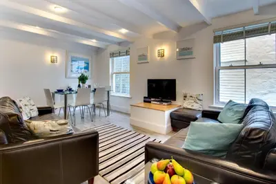 a living room with two leather couches and a television at 3 Bed in St Ives oc-bail05 in St Ives