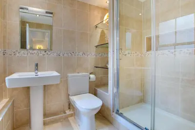a bathroom with a toilet and a sink and a shower at 3 Bed in St Ives oc-bail05 in St Ives