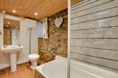 a bathroom with a tub and a toilet and a sink at 3 Bed in St Ives oc-bail06 in St Ives