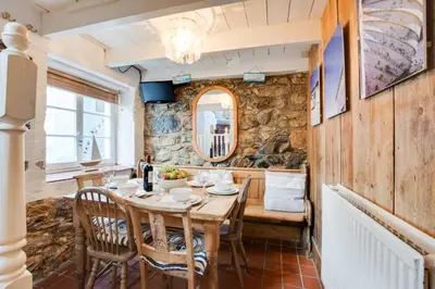 a dining room with a wooden table and chairs at 3 Bed in St Ives oc-bail06 in St Ives