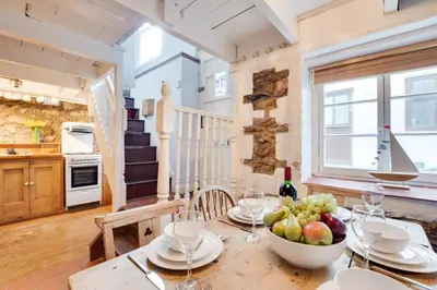 a dining room with a table with a bowl of fruit at 3 Bed in St Ives oc-bail06 in St Ives