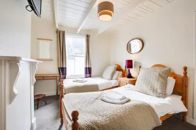 a bedroom with two beds and a mirror at 3 Bed in St Ives oc-bail06 in St Ives