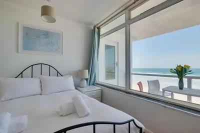 a bedroom with a bed with a view of the ocean at 2 Bed in St Ives oc-bpp15 in St Ives
