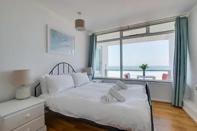 a bedroom with a bed and a large window at 2 Bed in St Ives oc-bpp15 in St Ives