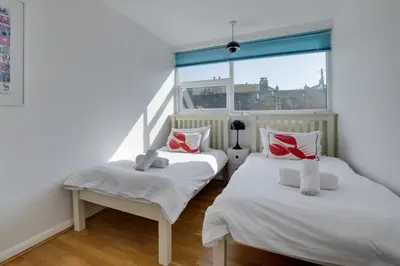 two twin beds in a room with a window at 2 Bed in St Ives oc-bpp15 in St Ives