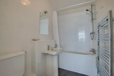 a white bathroom with a sink and a bath tub at 2 Bed in St Ives oc-bpp15 in St Ives