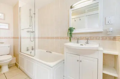 a white bathroom with a sink and a toilet at 1 Bed in St Ives oc-bpp21 in St Ives