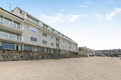 a building on the beach next to the sand at 1 Bed in St Ives oc-bpp21 in St Ives