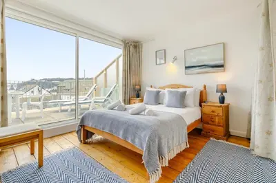 a bedroom with a bed and a large window at 1 Bed in St Ives oc-bpp21 in St Ives