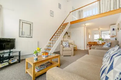 a living room with a couch and a staircase at 1 Bed in St Ives oc-bpp21 in St Ives