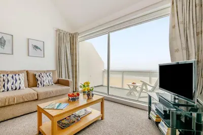 a living room with a couch and a large window at 1 Bed in St Ives oc-bpp21 in St Ives