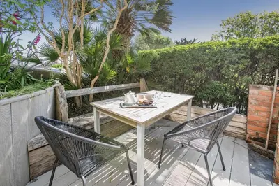 a table and two chairs on a patio at 4 Bed in St. Ives oc-brhous in St Ives