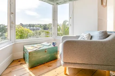 a living room with a couch and a large window at 4 Bed in St. Ives oc-brhous in St Ives