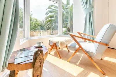 a living room with a chair and a table and a window at 4 Bed in St. Ives oc-brhous in St Ives