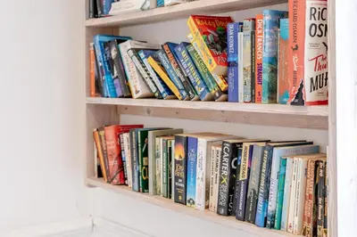 a book shelf filled with lots of books at 4 Bed in St. Ives oc-brhous in St Ives