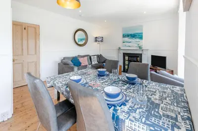 a dining room with a table and chairs at 4 Bed in St. Ives oc-brhous in St Ives