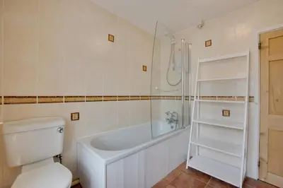 a bathroom with a white tub and a toilet and a shower at 3 Bed in St Ives oc-car17 in St Ives