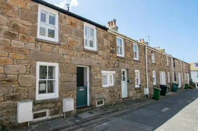 a brick building with white windows and doors on a street at 3 Bed in St Ives oc-car17 in St Ives