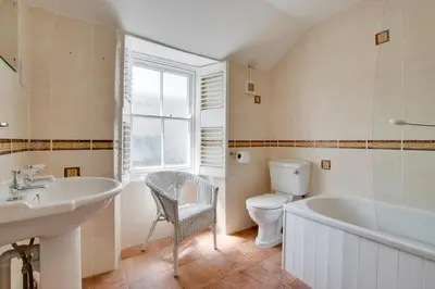 a bathroom with a sink and a tub and a toilet at 3 Bed in St Ives oc-car17 in St Ives