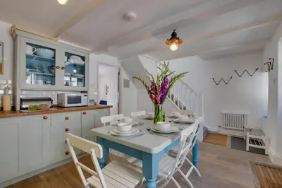 a kitchen and dining room with a table and chairs at 3 Bed in St Ives oc-car17 in St Ives
