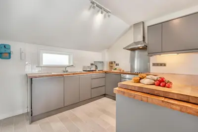 a kitchen with a counter with fruits and vegetables on it at 2 Bed in St Ives oc-chyr03 in St Ives