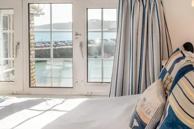 a bedroom with a bed with a view of the ocean at 2 Bed in St Ives oc-chyr03 in St Ives