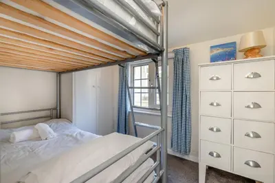 a bedroom with a bunk bed with a wooden ceiling at 2 Bed in St Ives oc-chyr03 in St Ives
