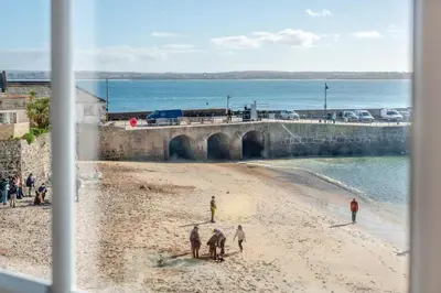 a group of people walking on the beach at 2 Bed in St Ives oc-chyr03 in St Ives