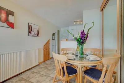 a dining room with a table with chairs and flowers at 1 Bed in St Ives oc-chyr2 in St Ives