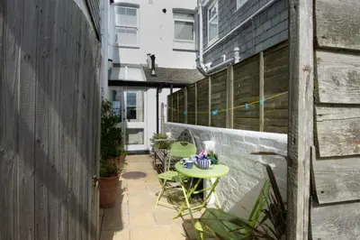 a small patio with a green table and chairs at 2 Bed in St Ives oc-clv2a in St Ives