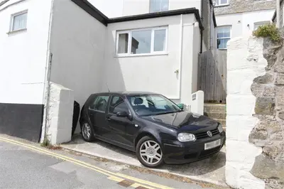 a black car parked in front of a house at 2 Bed in St Ives oc-clv2a in St Ives