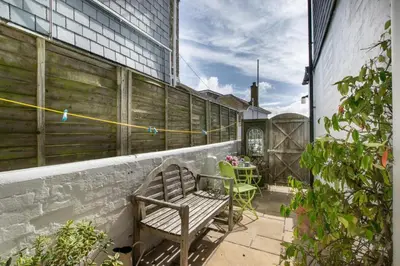 a bench sitting on the side of a building at 2 Bed in St Ives oc-clv2a in St Ives