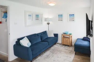a living room with a blue couch and a blue chair at 1 Bed in St Ives oc-crab02 in St Ives