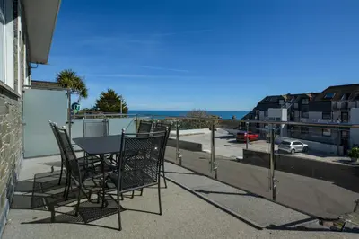 a table and chairs on a balcony with a view of a street at 1 Bed in St Ives oc-clear2 in St Ives