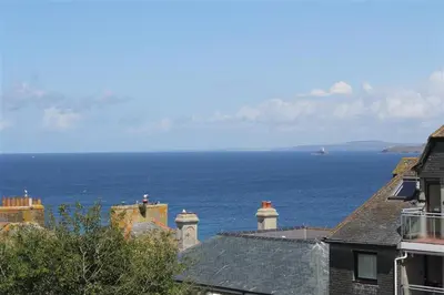 a view of the ocean from the roofs of houses at 1 Bed in St Ives oc-clear2 in St Ives