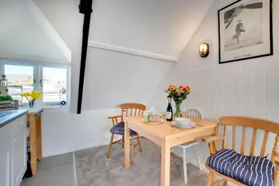 a kitchen and dining room with a table and chairs at 1 Bed in St. Ives oc-cp5 in St Ives