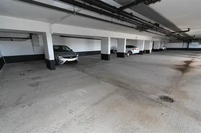 two cars parked in an empty parking garage at 1 Bed in St Ives oc-cwn014 in St Ives